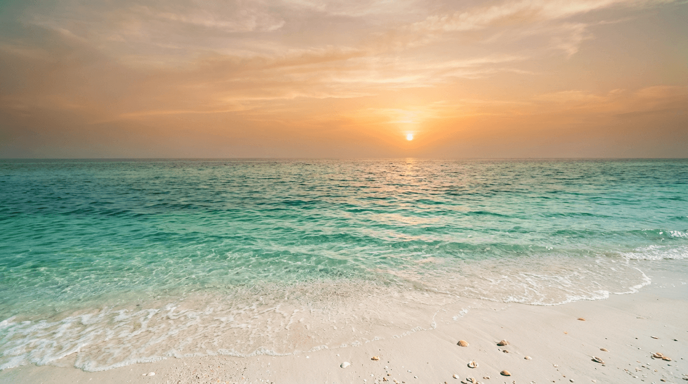 Calm ocean at sunset with warm golden light over gentle waves